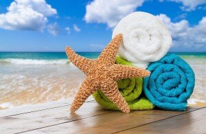 Summer beach towels with starfish against ocean background
